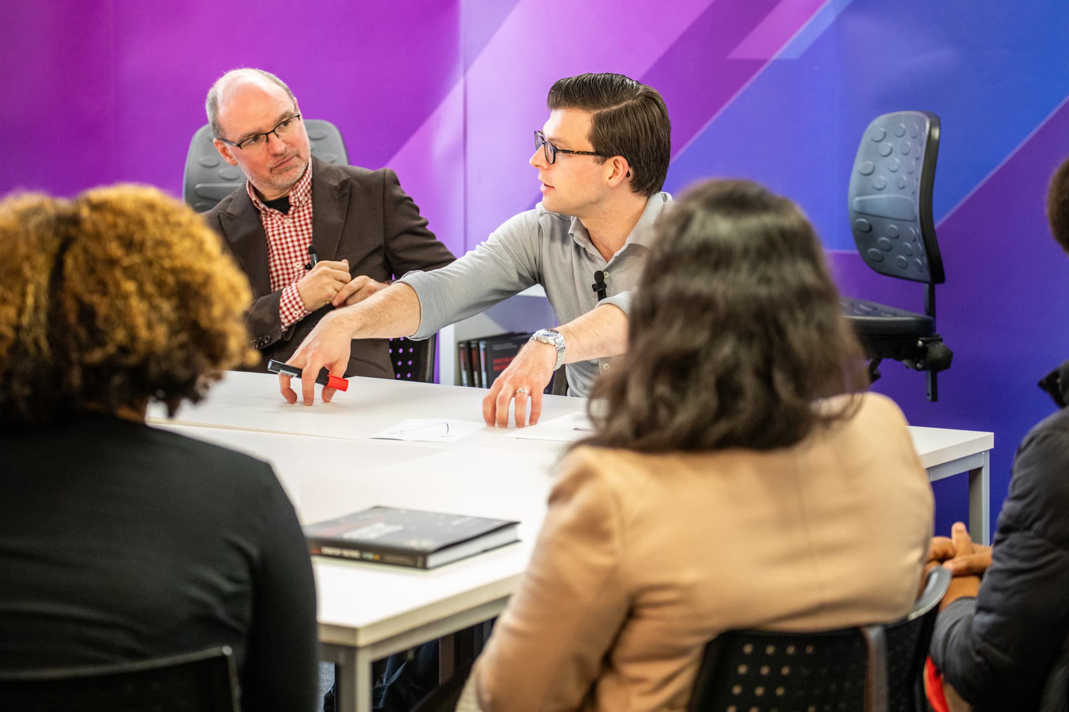 Paul Cheek in a working session with directors